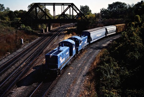 Westbound Conrail freight train in Toledo, Ohio, on October 15, 1983. The view is from Miami Street, and the train is coming off the ex-Pennsylvania Railroad and onto the former New York Central (NYC) toward the downtown station. The track just above the lead locomotive was the Baltimore & Ohio’s passenger line to the NYC station. Photograph by John F. Bjorklund, © 2015, Center for Railroad Photography and Art. Bjorklund-29-07-05