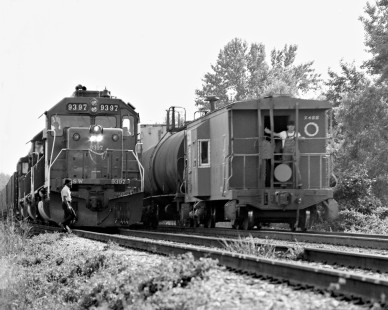 Southern Railway conductor gives a wave as his train slips past northbound at Pachuta, Mississippi, in May 1975. Photograph by J. Parker Lamb, © 2016, Center for Railroad Photography and Art. Lamb-01-113-05