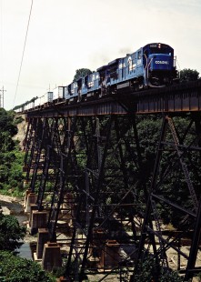 Eastbound Conrail freight train crossing trestle near Swanville, Pennsylvania, on June 29, 1985. The train is being detoured on Norfolk Southern's former Nickel Plate Road main line, which runs parallel to Conrail's former New York Central main line. Photograph by John F. Bjorklund, © 2015, Center for Railroad Photography and Art. Bjorklund-29-17-17