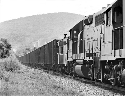 Pusher locomotives boost Chattanooga-bound Louisville and Nashville Railroad coal train as it starts climb up Cowan Hill, Tennessee, in August 1965. Exhaust from lead power is visible in the distance. Photograph by J. Parker Lamb, © 2016, Center for Railroad Photography and Art. Lamb-01-148-01