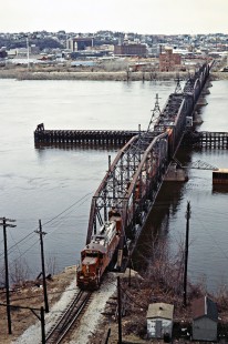 Eastbound Illinois Central Gulf Railroad freight train crossing the Mississippi River at East Dubuque, Illinois (Dubuque, Iowa, is in the background), on April 7, 1984. Photograph by John F. Bjorklund, © 2016, Center for Railroad Photography and Art. Bjorklund-60-18-03