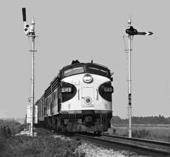 Gaining speed on the main line, southbound <i>Southerner</i> passenger train no. 47 slices between semaphore signals at mile post 4.6 on New Orleans and Northeastern Railroad trackage about five miles from the station in Meridian, Mississippi, in August 1954. Photograph by J. Parker Lamb, © 2016, Center for Railroad Photography and Art. Lamb-01-106-06