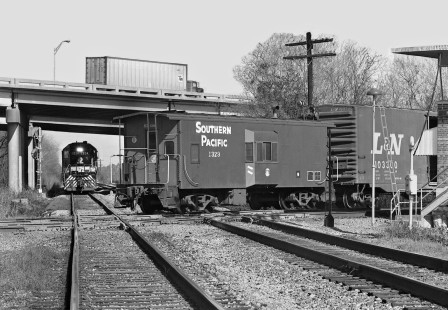 Inbound Southern Railway local train waits at N.E. Tower in New Orleans, Louisiana, as a joint Southern Pacific Railroad-Louisville and Nashville Railroad run-through train clears the crossing in January 1981. Photograph by J. Parker Lamb, © 2016, Center for Railroad Photography and Art. Lamb-01-115-06