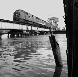 New Orleans-bound Louisville and Nashville Railroad <i>Humming Bird</i> passenger train crosses swing bridge at Pascagoula, Mississippi, in August 1958. (Note: diesel paint schemes show transition to solid dark blue.) Photograph by J. Parker Lamb, © 2016, Center for Railroad Photography and Art. Lamb-01-140-06