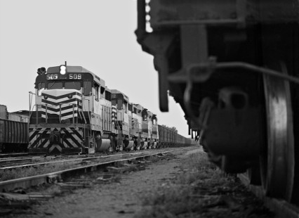 Northbound iron ore train pulls into yard in Meridian, Mississippi, at dusk in August 1964. Venezuelan ore was transloaded at Mobile, Alabama, and is en route to steel mills in Birmingham. Photograph by J. Parker Lamb, © 2016, Center for Railroad Photography and Art. Lamb-01-125-01
