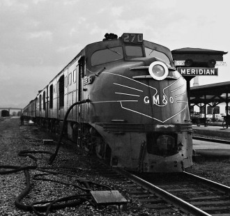 It is dusk as the northbound Gulf, Mobile and Ohio Railroad <i>Gulf Coast Rebel</i> stops in Meridian, Mississippi, and its DL-109 units take on water for their steam generators in August 1954. Photograph by J. Parker Lamb, © 2016, Center for Railroad Photography and Art. Lamb-01-132-06