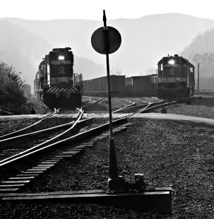 Southbound coal train (left) departs from yard in Appalachia, Virginia, on a foggy morning in October 1978. This trackage was initially owned by the Interstate Railroad. Photograph by J. Parker Lamb, © 2016, Center for Railroad Photography and Art. Lamb-01-121-01