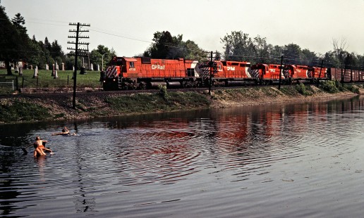 Eastbound Canadian Pacific Railway freight train and swimmers at Campbellville, Ontario, on May 24, 1980. Photograph by John F. Bjorklund, © 2015, Center for Railroad Photography and Art. Bjorklund-37-12-13