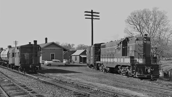 Southern Railway crew members exchange greetings as a Meridian-bound freight train passes the local train at the station in Epes, Alabama, in December 1954. Photograph by J. Parker Lamb, © 2016, Center for Railroad Photography and Art. Lamb-01-115-08