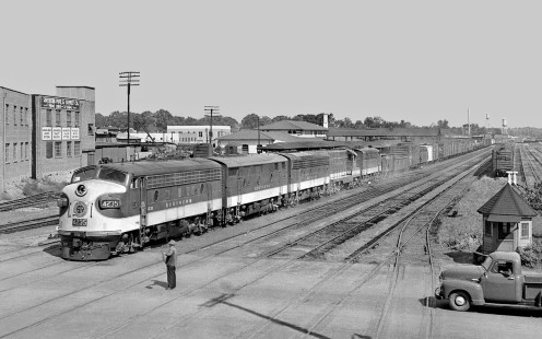 The classic flagman was present in June 1954 at Meridian's 22nd Avenue to warn motorists about trains from every rail company that served the Mississippi city. Here, Southern Railway freight train no. 153 for New Orleans eases across in a view from Gulf, Mobile and Ohio Railroad's reefer-icing platform that served northbound banana trains. Meridian Union Station is above the last diesel units. (World War II folklore is that around 100 trains passed this point daily.) Photograph by J. Parker Lamb, © 2016, Center for Railroad Photography and Art. Lamb-01-107-03