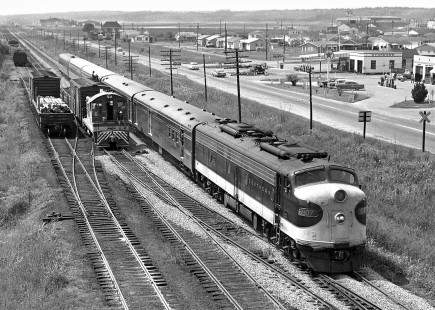 Northbound Southern Railway <i>Southerner</i> passenger train slides past industrial switcher near south end of yard at Meridian, Mississippi, in August 1970. In background is Meridian's airport, a World War II air base, and before that, site of a record for time aloft by two locals, the Key Brothers. They spend months flying around the city in biplanes and refueling with a hose between planes. Photograph by J. Parker Lamb, © 2016, Center for Railroad Photography and Art. Lamb-01-111-02