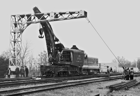 On a cold December morning in 1951, it took both steam and diesel-electric power to erect a signal bridge at the busy crossing of the Illinois Central Railroad; Gulf, Mobile & Ohio Railroad; and Southern Railway lines between downtown and the joint IC-SR yard. Photograph by J. Parker Lamb, © 2016, Center for Railroad Photography and Art. Lamb-01-103-02