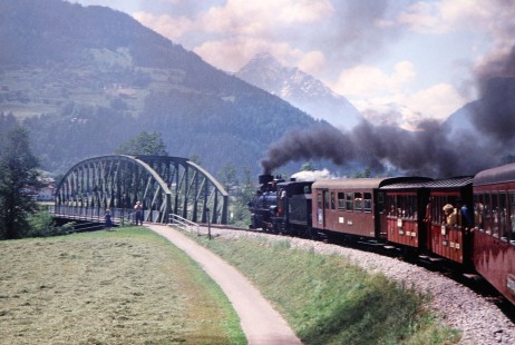 A view of Ybbs Valley Railway steam locomotive as it takes the curved track away from Mayrhofen and toward a bridge in Linz, Upper Austria, Austria, on May 23, 2001. Photograph by Fred M. Springer, © 2014, Center for Railroad Photography and Art. Springer-Austria-19-31
