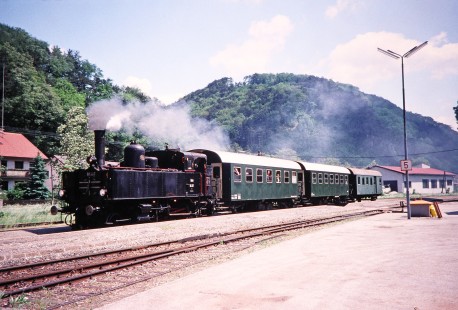 Association of Railway Friends (Verband der Eisenbahnfreunde) steam locomotive no. 91.107 begins to move from the station area with 3 passenger cars in Weibenbach, Lower Austria, Austria, on May 19, 2001. Photograph by Fred M. Springer, © 2014, Center for Railroad Photography and Art. Springer-Austria-13-23