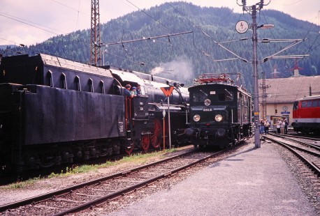 The engineer of Austrian Society for Railway History 2-8-4 steam locomotive no. 12.14 greets electric boxcab locomotive no. 1080.01 as it leaves the station in Selzthal, Upper Austria, Austria, on May 24, 2001. Photograph by Fred M. Springer, © 2014, Center for Railroad Photography and Art. Springer-Austria-21-11