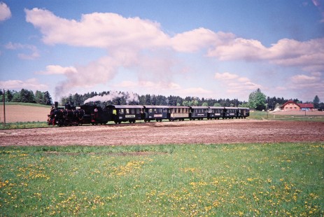 Waldviertler Narrow-Gauge Railway Club steam locomotive no. 399.04 moves leisurely through open fields near Nagelberg, Brand-Nagelberg, Austria, on May 12, 2001. Photograph by Fred M. Springer, © 2014, Center for Railroad Photography and Art. Springer-Austria-03-13