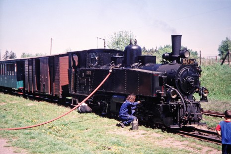 A young boy looks on as two workers service Jindřichův Hradec narrow gauge railway steam locomotive no. U47-001 in Hurky, Lower Austria, Austria, on May 14, 2001. Photograph by Fred M. Springer, © 2014, Center for Railroad Photography and Art. Springer-Austria-07-17