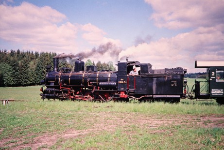 A clear profile view of Waldviertler Narrow-Gauge Railway Club 0-8-4T steam locomotive no. 399.04 with passenger car in Brand, Lower Austria, Austria, on May 12, 2001. Photograph by Fred M. Springer, © 2014, Center for Railroad Photography and Art. Springer-Austria-04-38