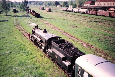 Waldviertler Narrow-Gauge Railway Club steam locomotive no. 86.98 pulls into the grassy yard at Ceske Valenice, Lower Austria, Austria, on May 14, 2001. Photograph by Fred M. Springer, © 2014, Center for Railroad Photography and Art. Springer-Austria-08-33
