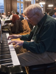 Attendee Charlie Castner delights crowd with impromptu piano performance at Saturday night dinner. Center for Railroad Photography & Art. Photograph by Henry A. Koshollek.