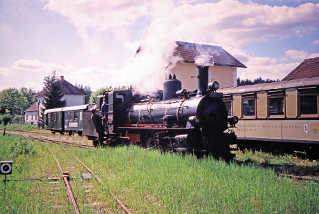 Waldviertler Narrow-Gauge Railway Club 0-8-4T steam locomotive no. 399.04 and its rail workers in the tall grass at Litschau yard in Gmünd, Lower Austria, Austria, on May 12, 2001. Photograph by Fred M. Springer, © 2014, Center for Railroad Photography and Art. Springer-Austria-04-28