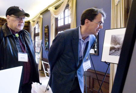 Den Adler and Todd Halamka viewing Wallace Abbey prints at Friday night reception. Center for Railroad Photography & Art. Photograph by Henry A. Koshollek.