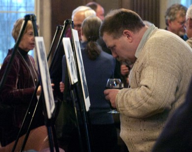 Kevin Varrato studies the Stan Kistler photography exhibition on Friday evening.