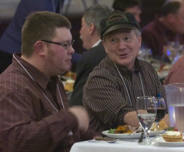 North Dakotan Lewis Ableidinger and South Dakotan Kent Staubus confer over dinner on Friday.