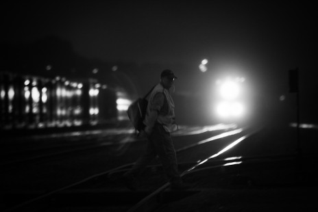 <strong>Travis Dewitz, Altoona, Wisconsin</strong>
The local job is done as an Union Pacific conductor walks across the tracks to the Altoona depot as an incoming freight pulls into the yard.

<strong>Judge's Comment:</strong>
Night work. Love it!