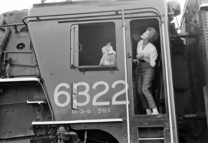 A child waves from the cab of Grand Trunk Western steam locomotive no. 6322. It is leading an Illini Railroad Club excursion through Battle Creek, Michigan on November 13, 1960. Gruber-02-045-0129